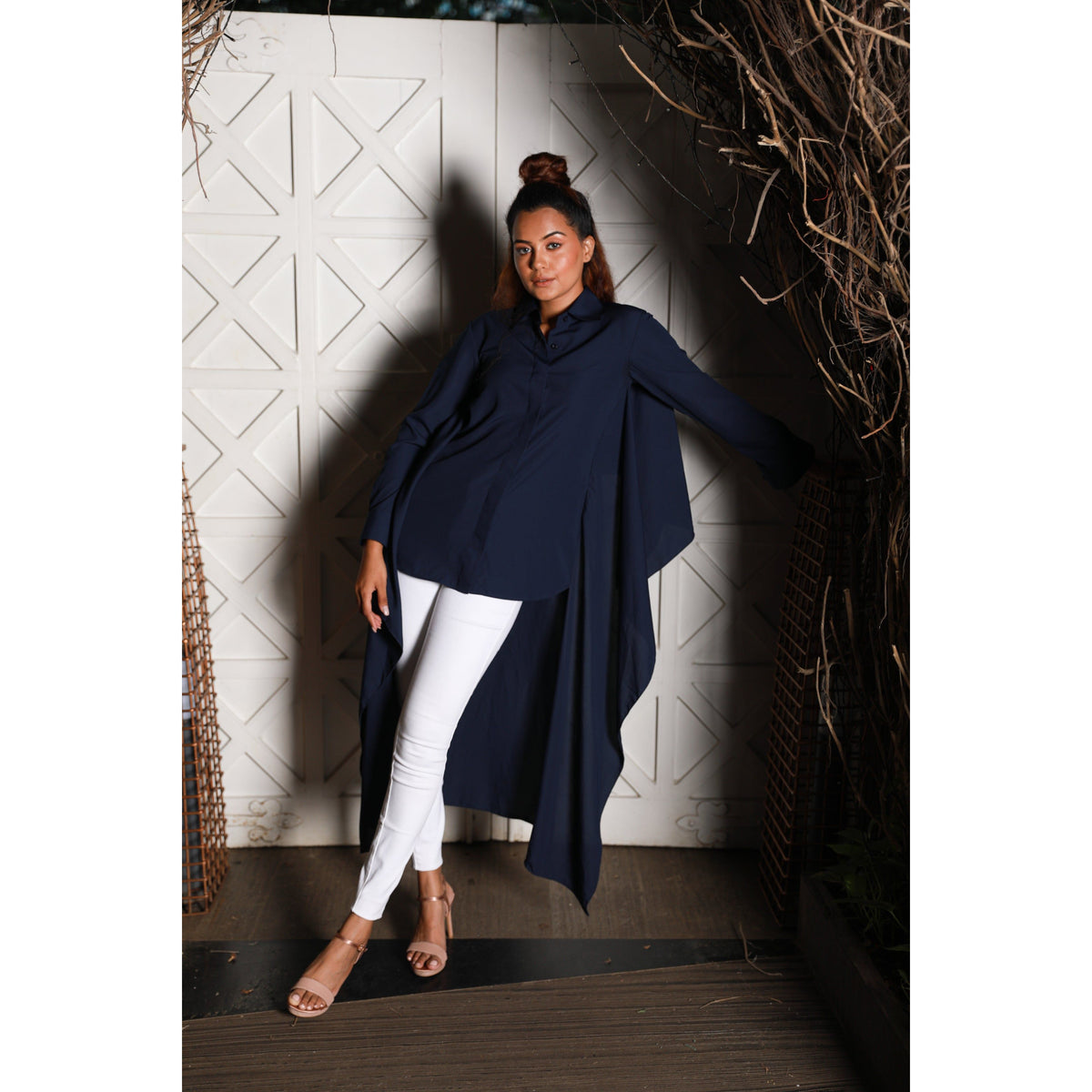 Asymmetric blue shirt features an extended back and full sleeves.