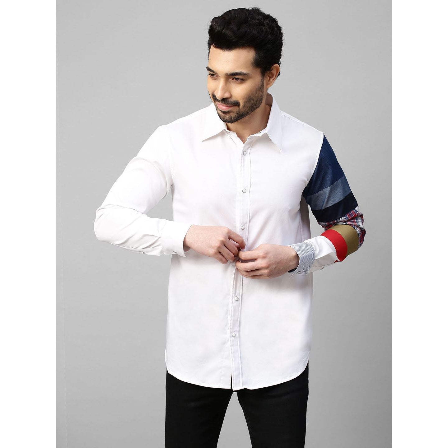 White shirt with patch detailing on one sleeve.