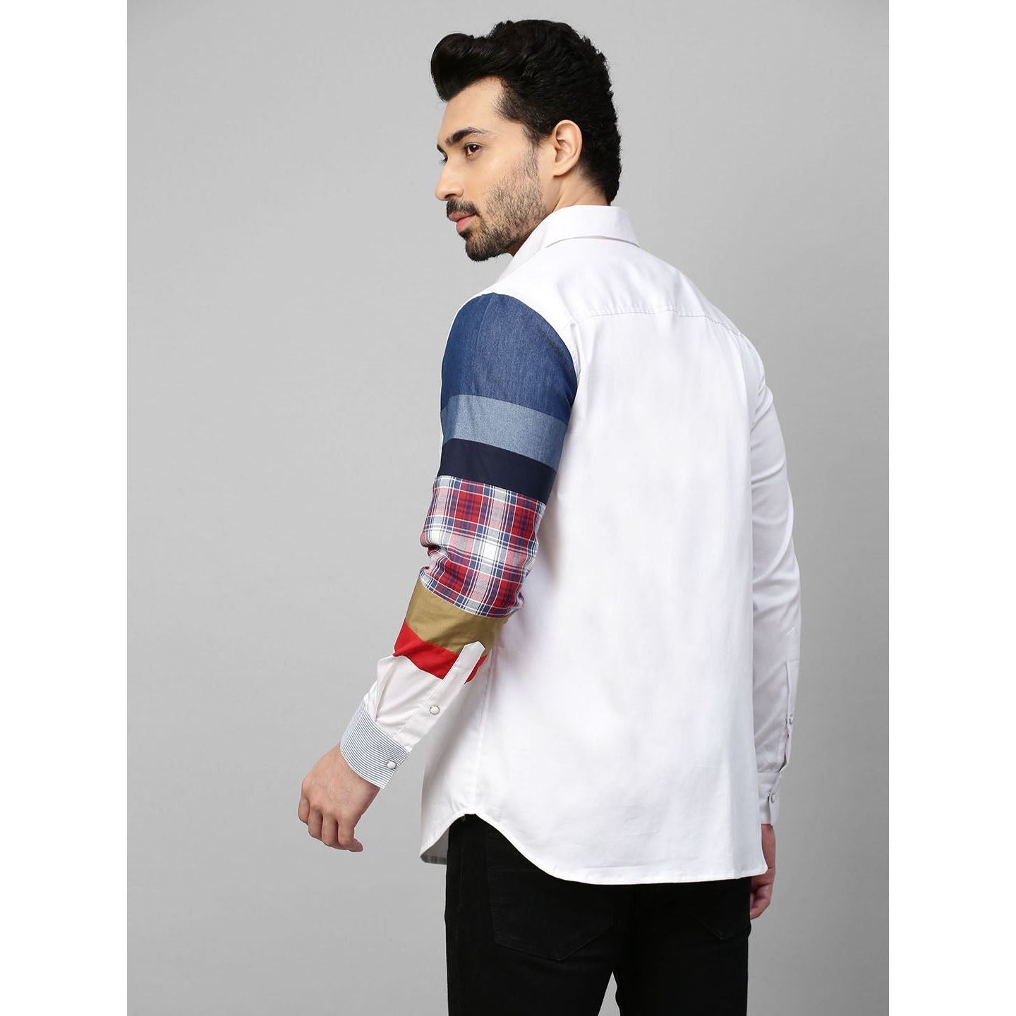 White shirt with patch detailing on one sleeve.