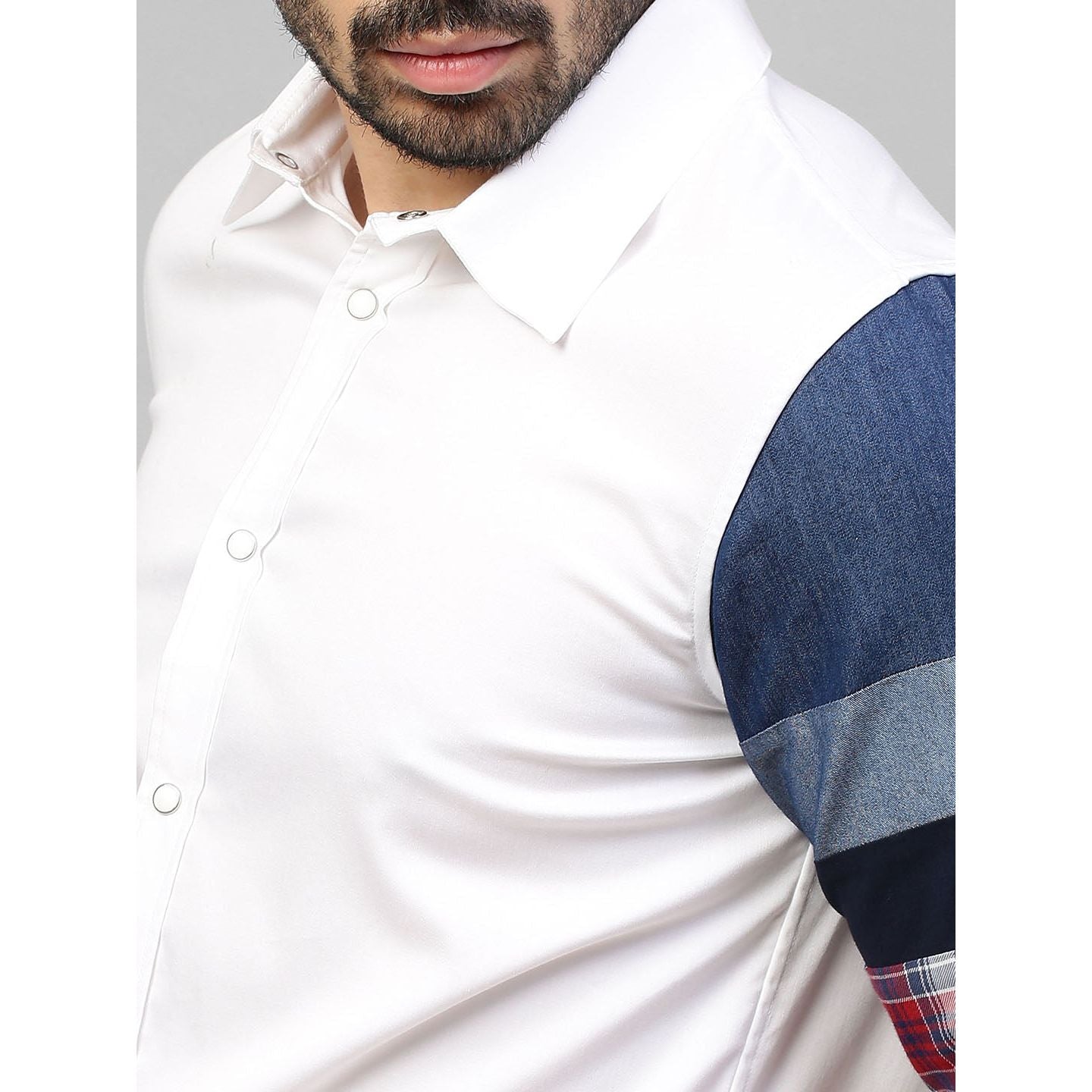 White shirt with patch detailing on one sleeve.