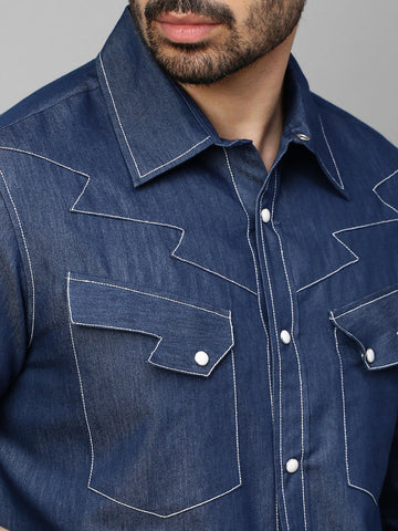 Denim shirt with contrast stitching feature.