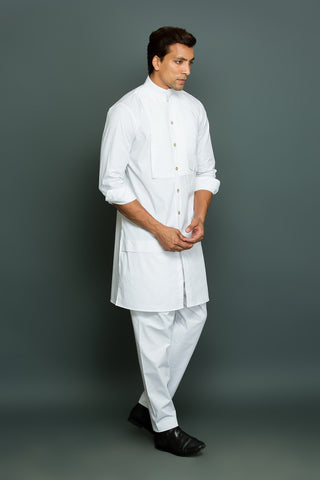 White kurta with front pleated panel and pocket with pants.