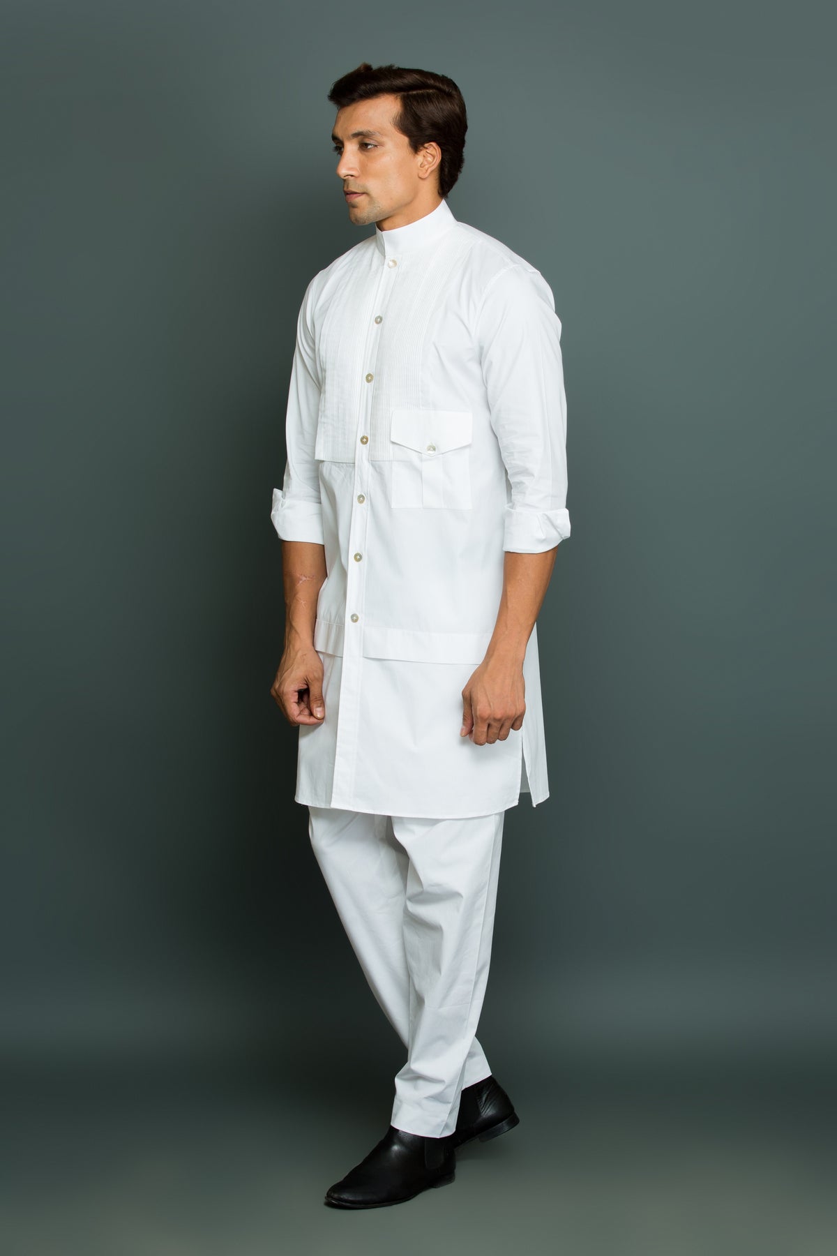 White kurta with front pleated panel and pocket with pants.