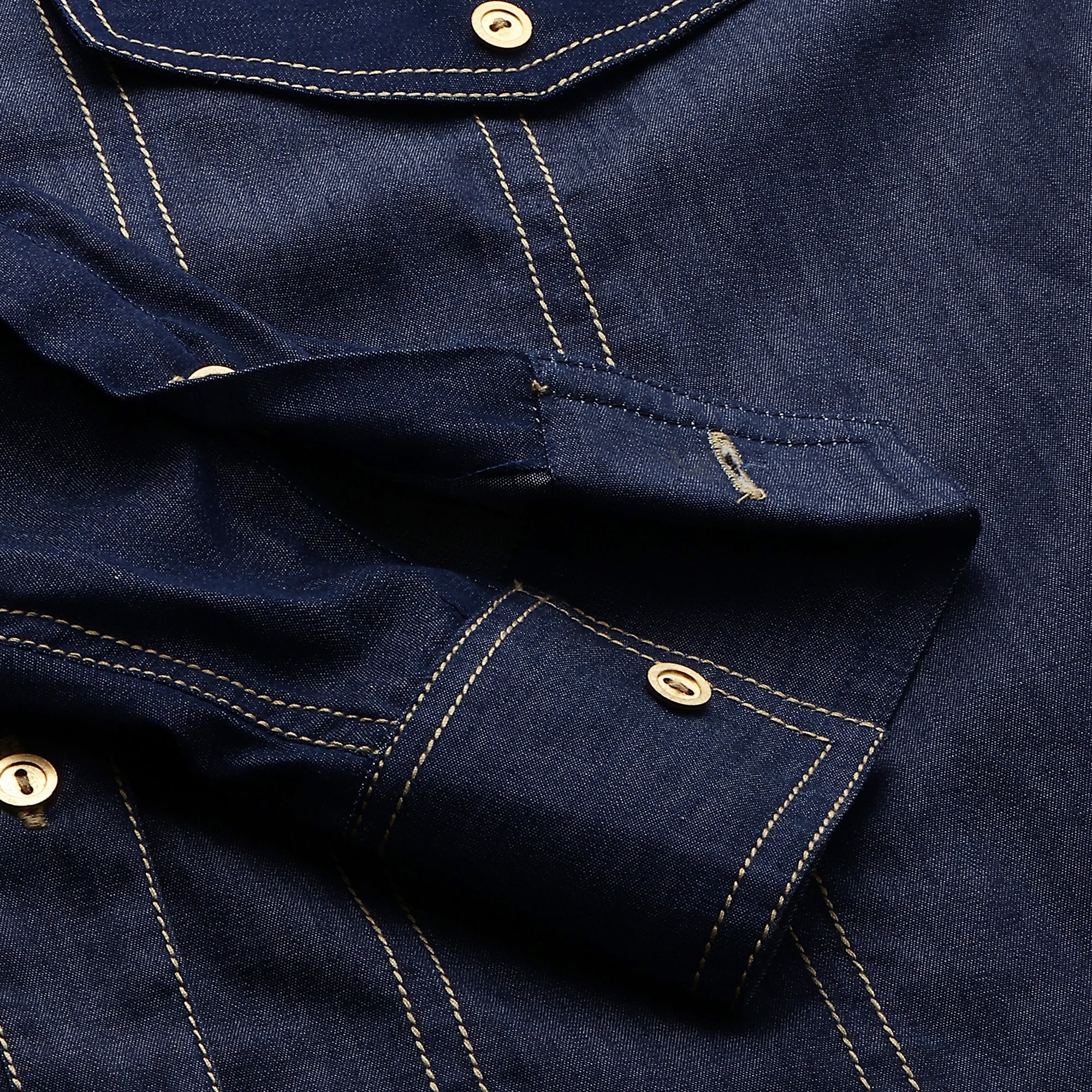 Denim button-down shirt features full sleeves and a red embellished cross.