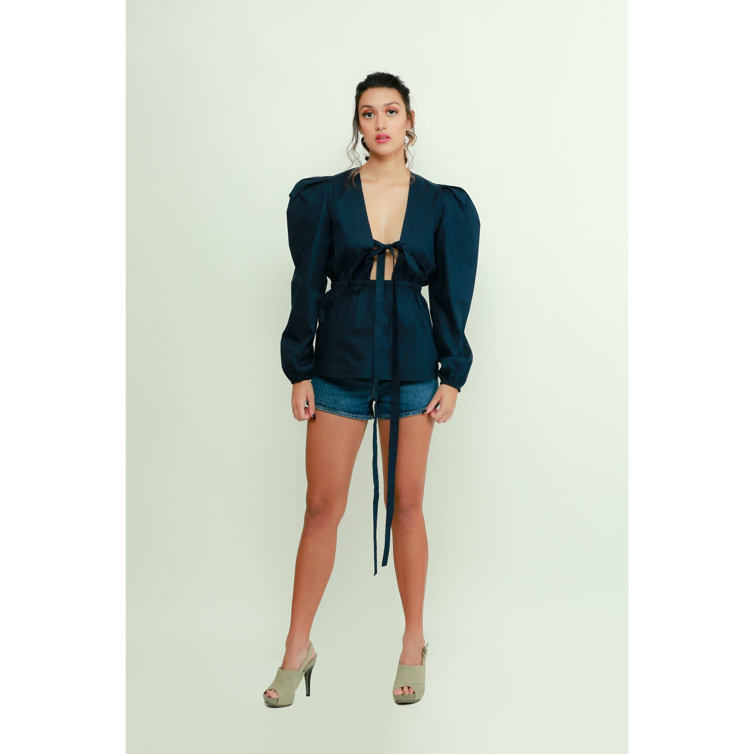 Dark blue top features a tie-up detailing, balloon sleeves.