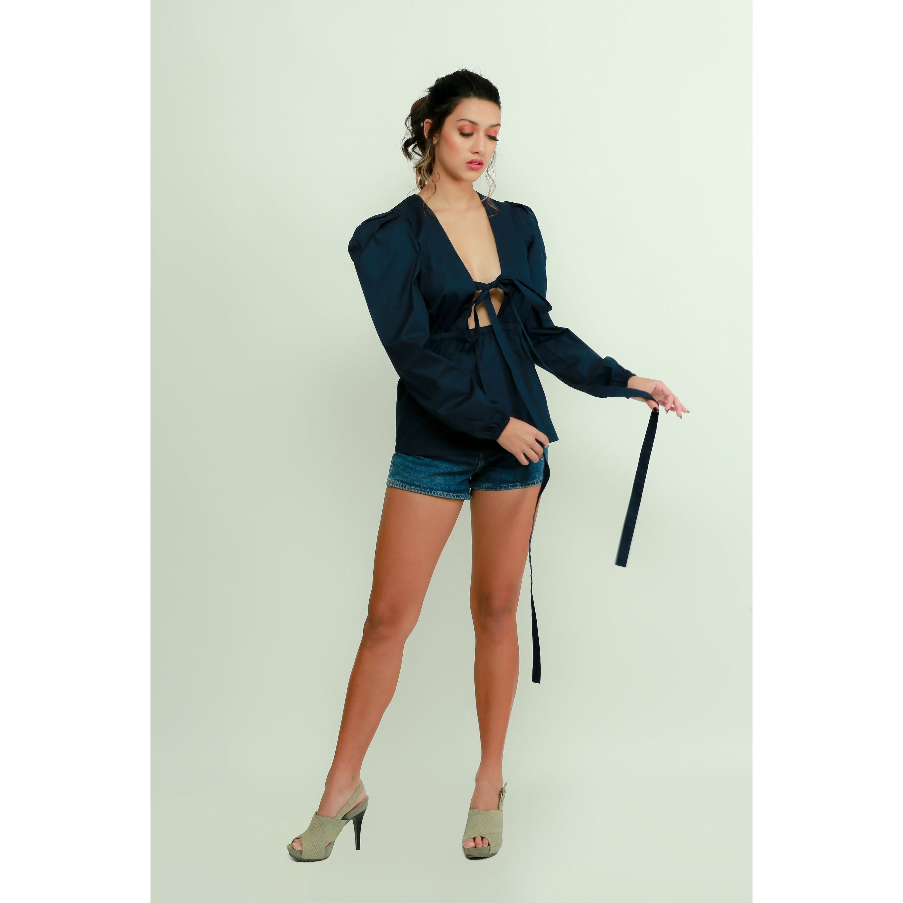 Dark blue top features a tie-up detailing, balloon sleeves.