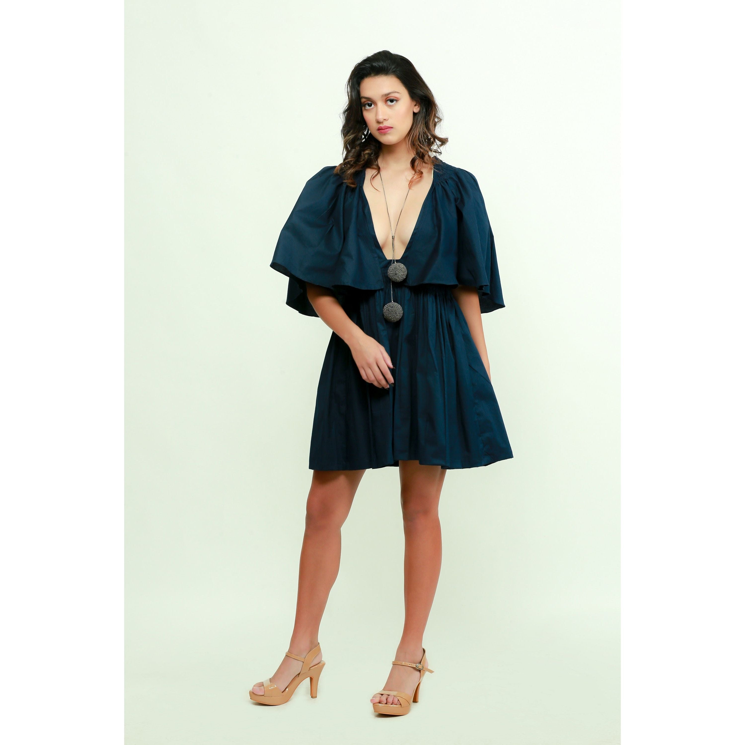 Dark blue skater dress features a plunging neckline and flared sleeves.