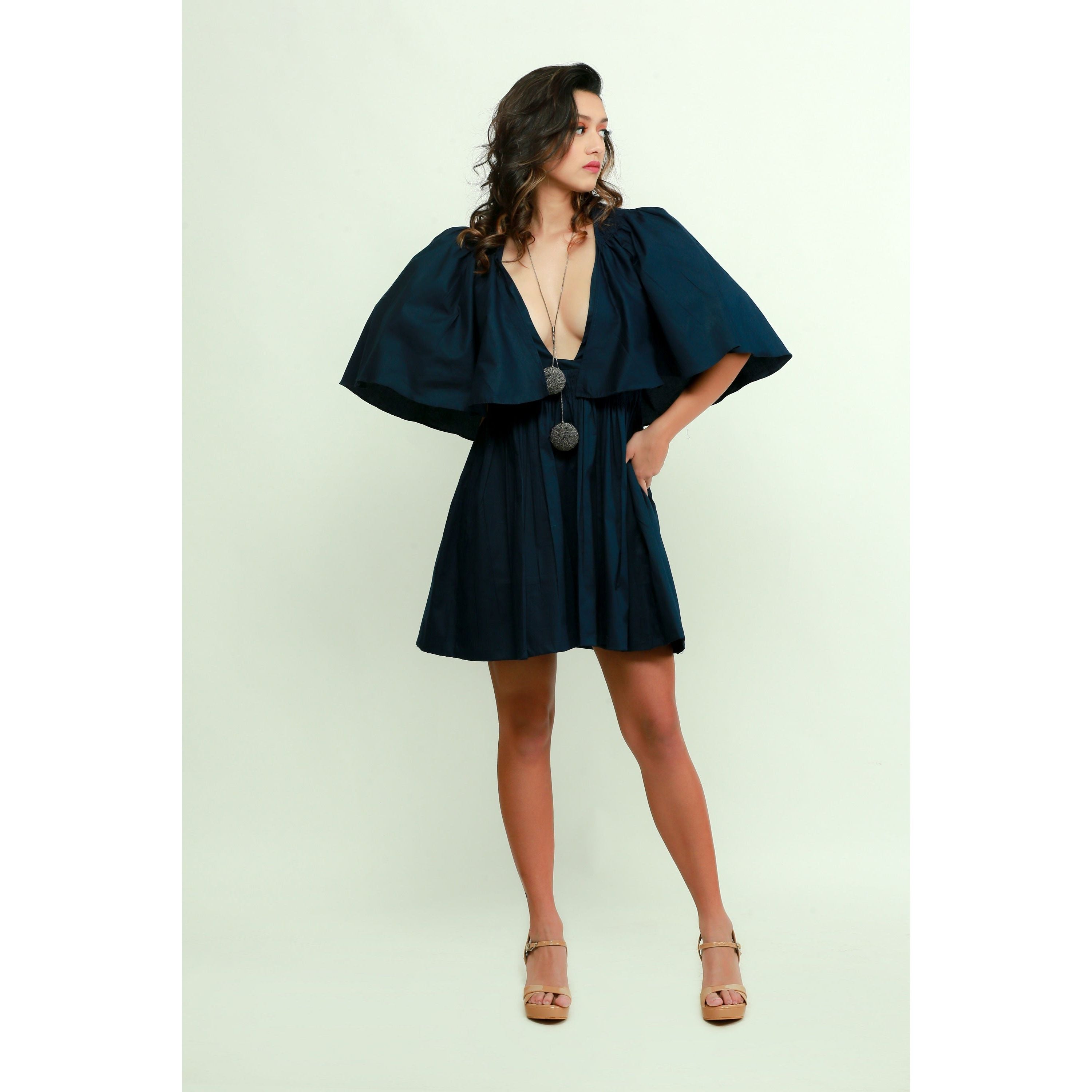 Dark blue skater dress features a plunging neckline and flared sleeves.