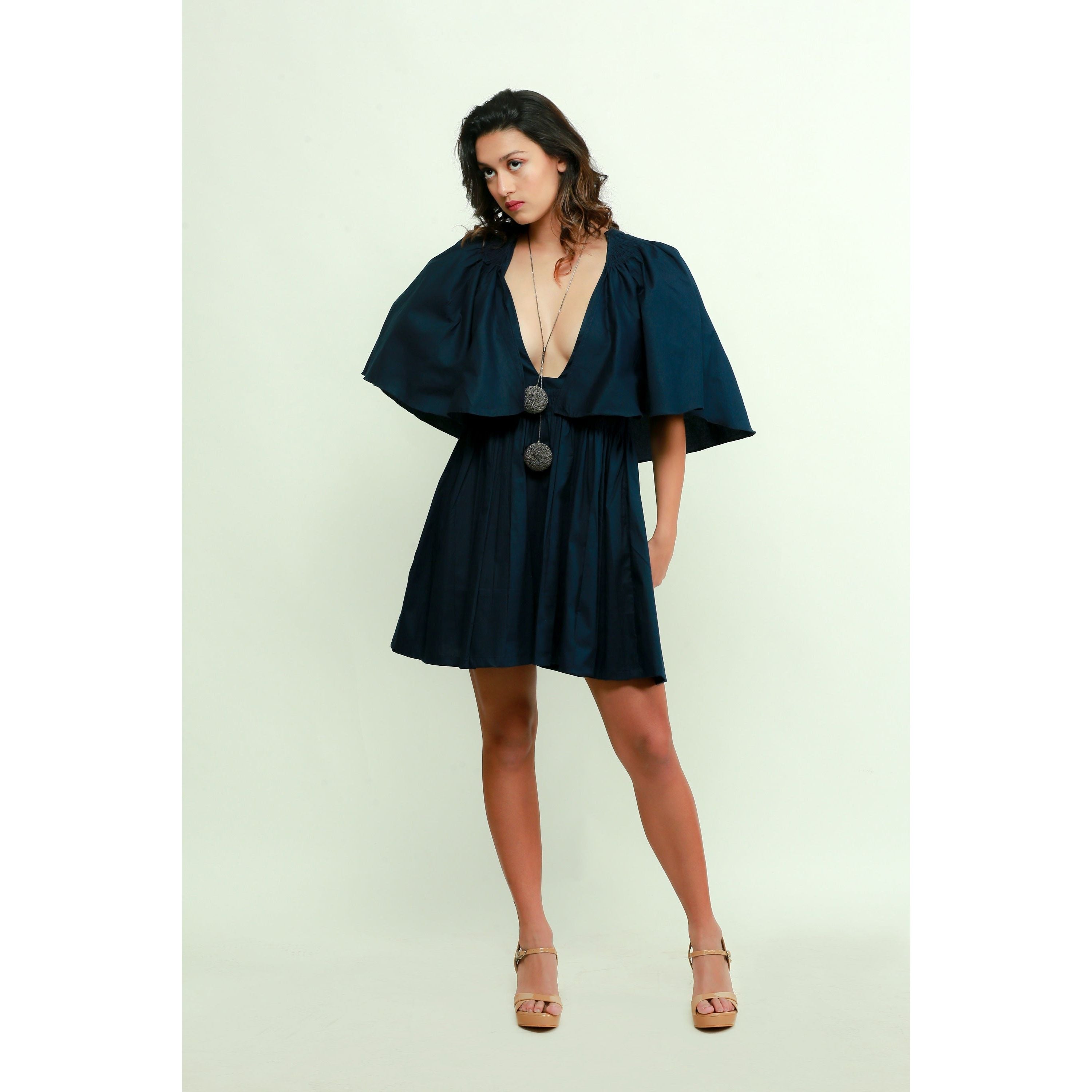 Dark blue skater dress features a plunging neckline and flared sleeves.