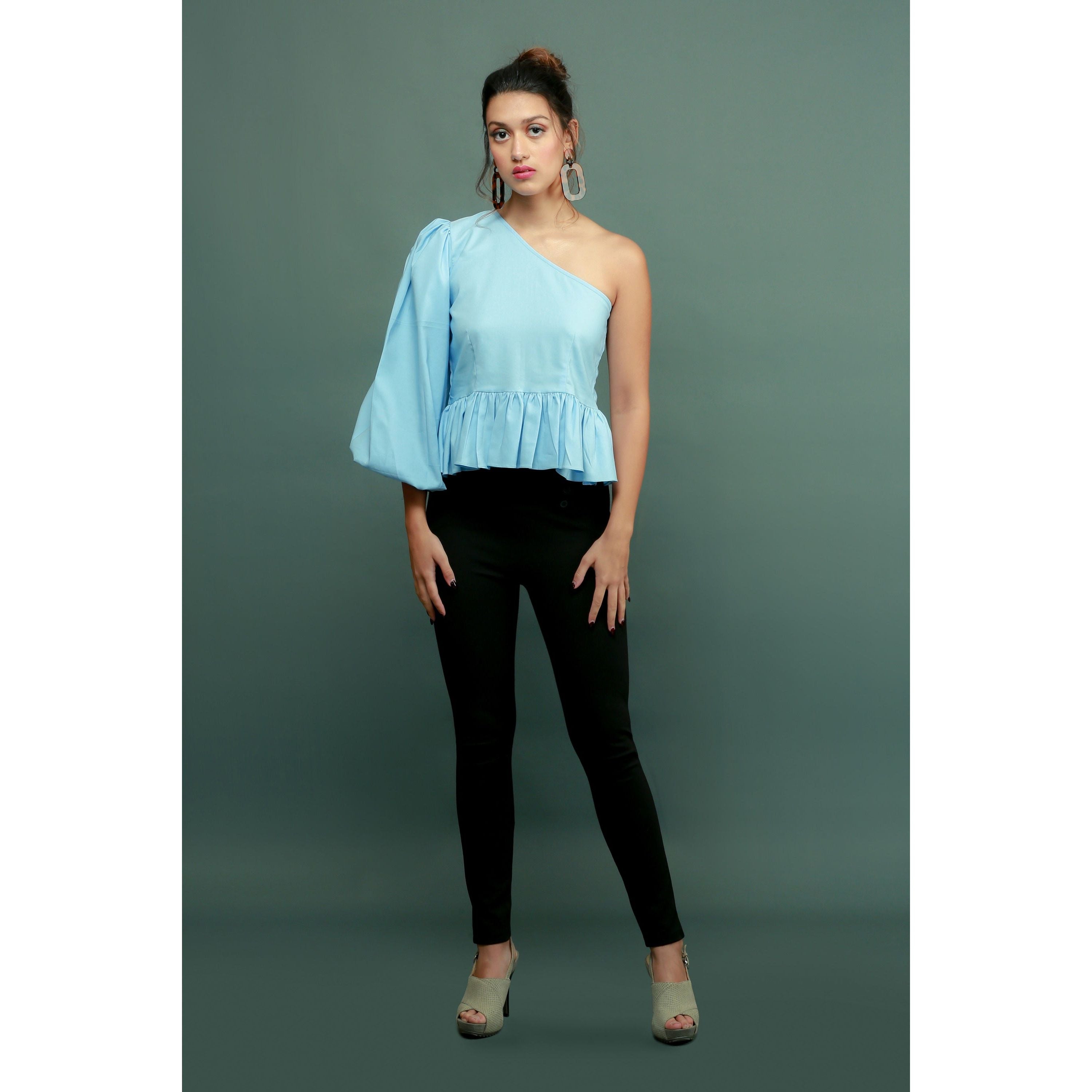 Light blue one-shoulder top features a peplum waist and balloon sleeves.