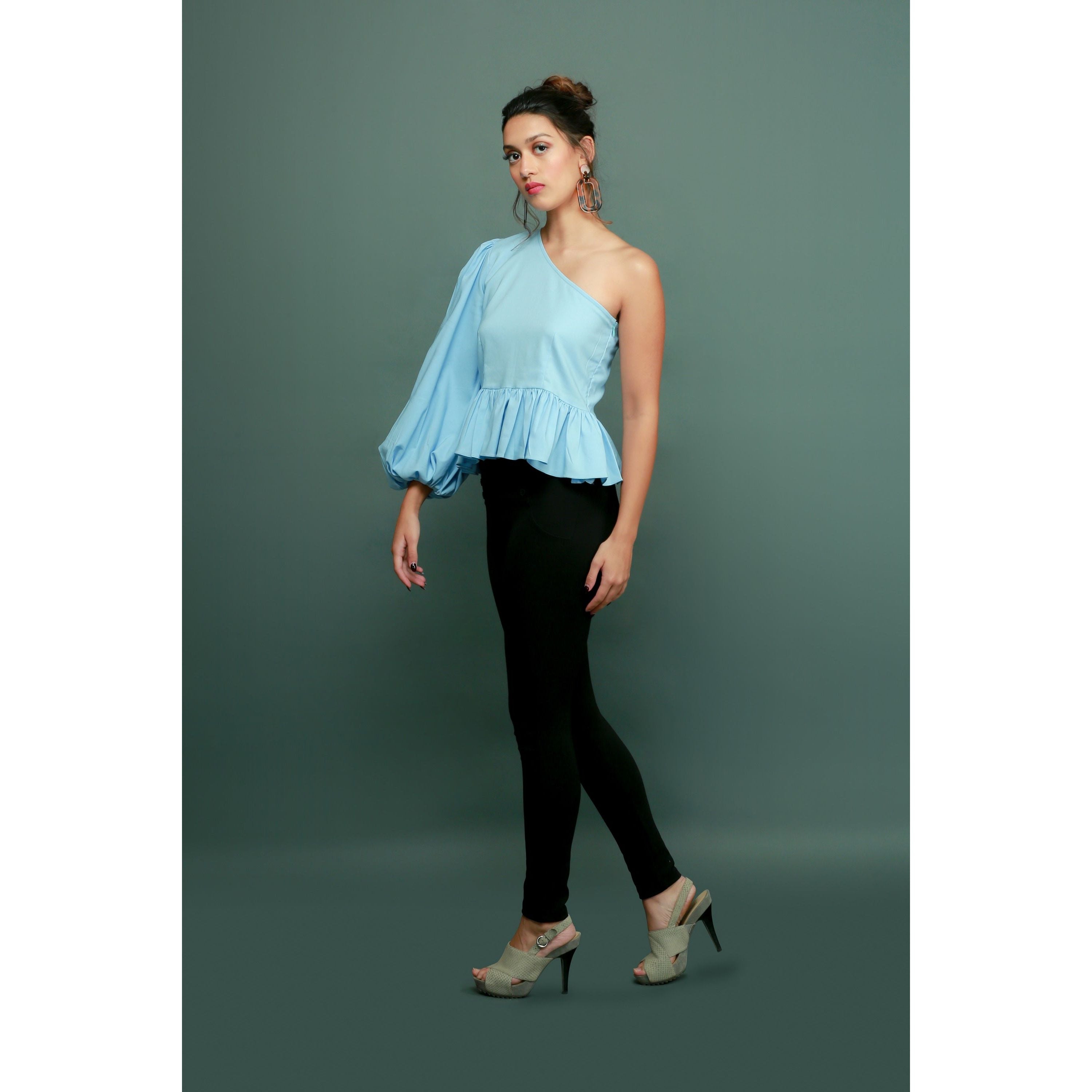 Light blue one-shoulder top features a peplum waist and balloon sleeves.