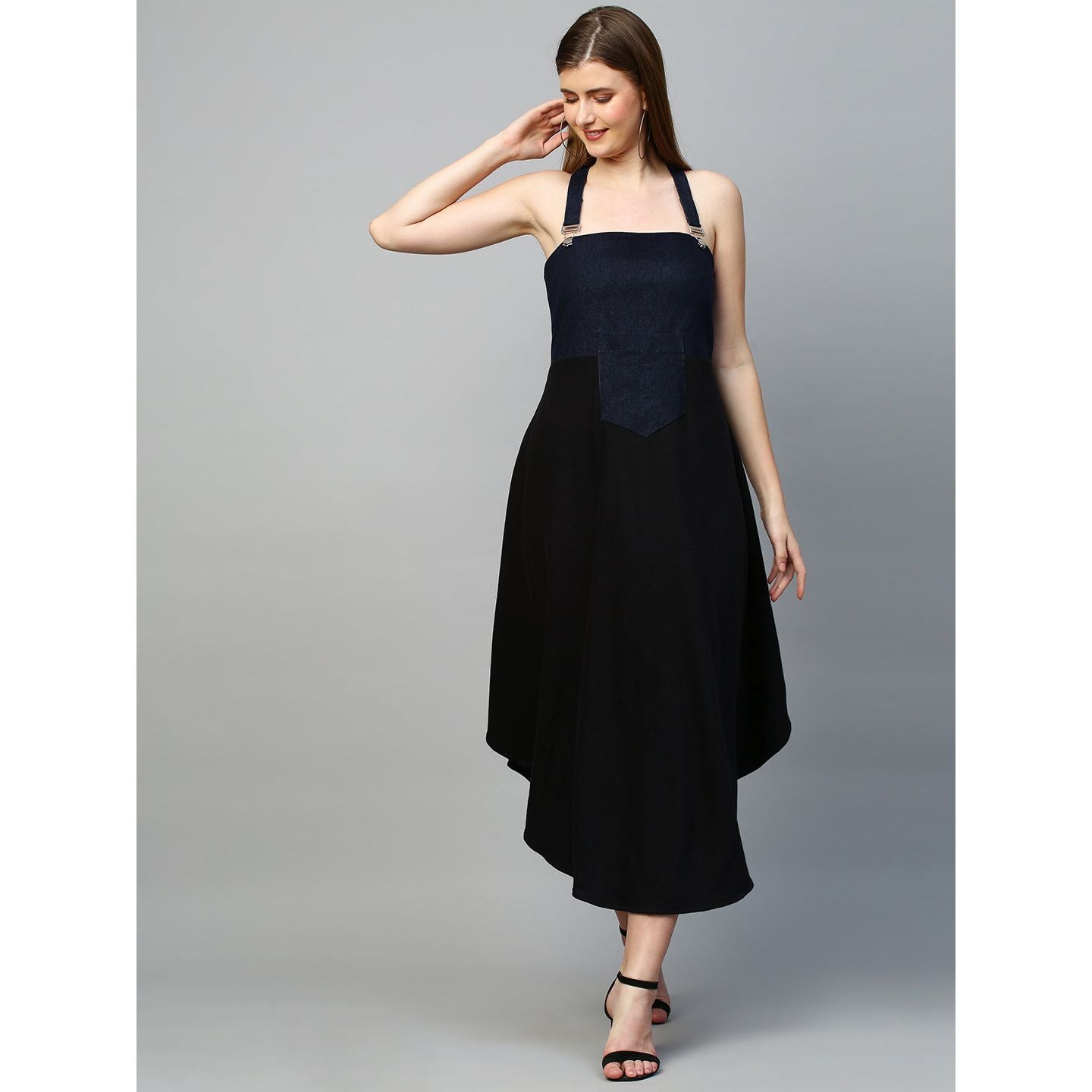 Denim dungaree dress features an assymmetric hemline.