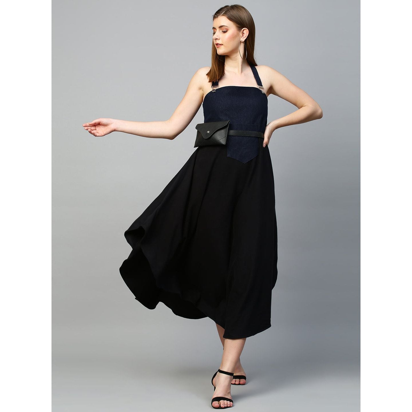 Denim dungaree dress features an assymmetric hemline.