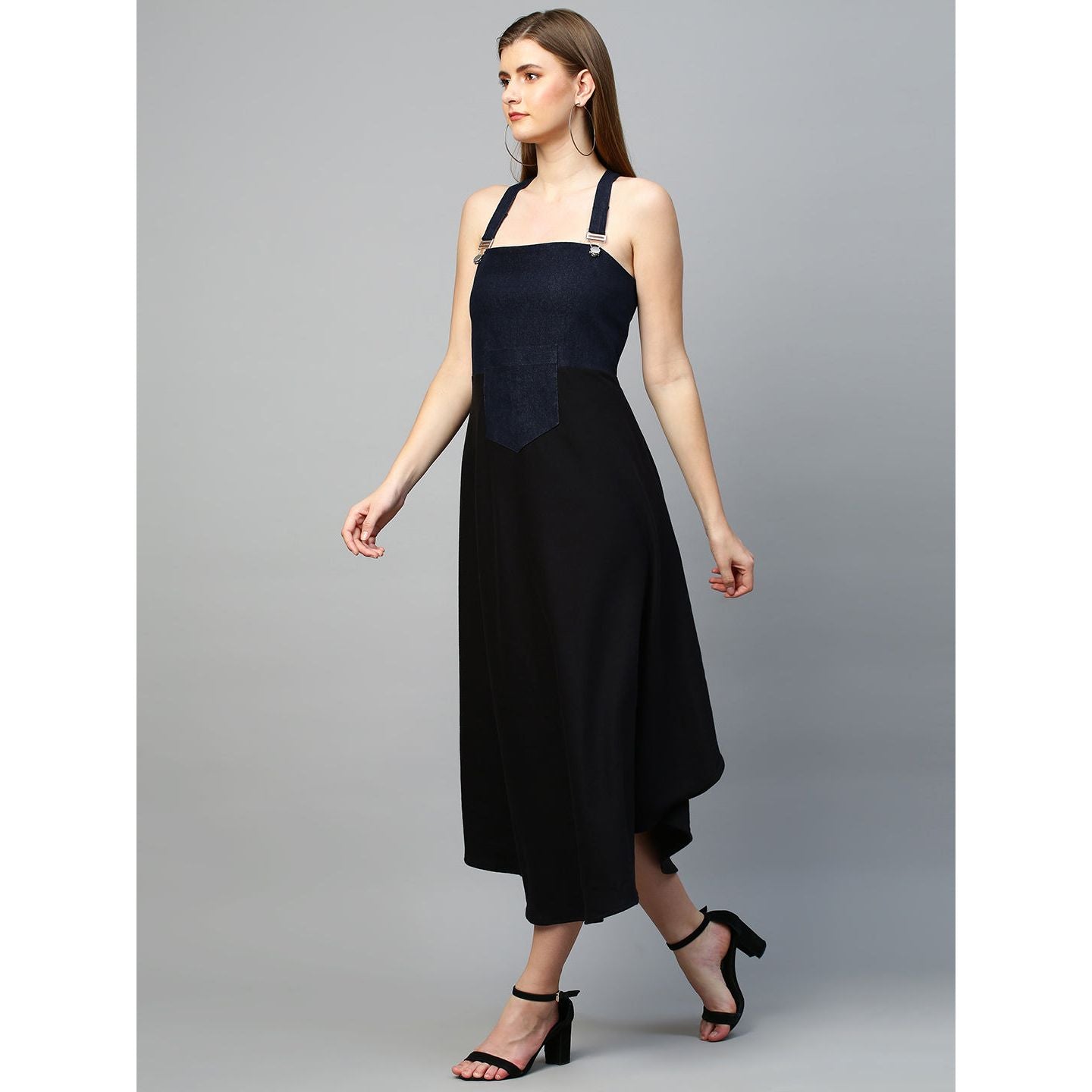 Denim dungaree dress features an assymmetric hemline.