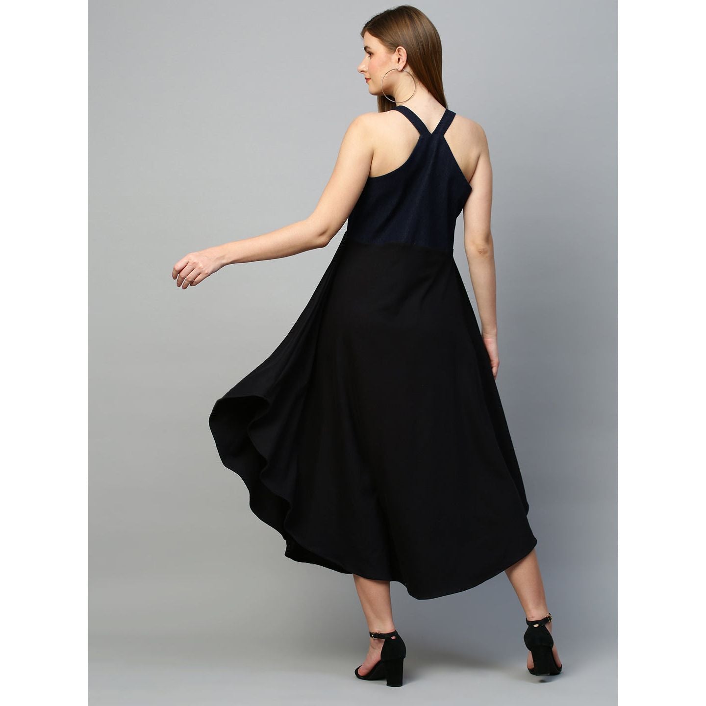 Denim dungaree dress features an assymmetric hemline.