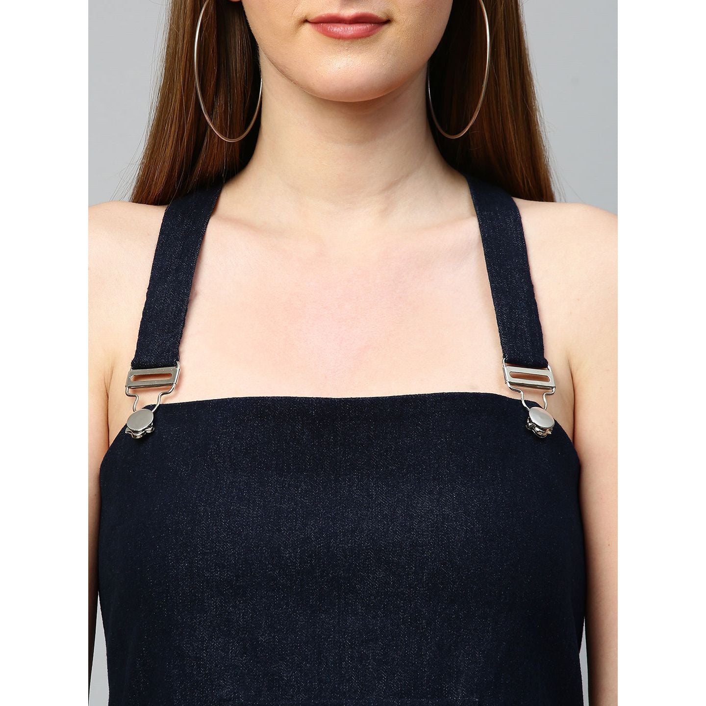 Denim dungaree dress features an assymmetric hemline.