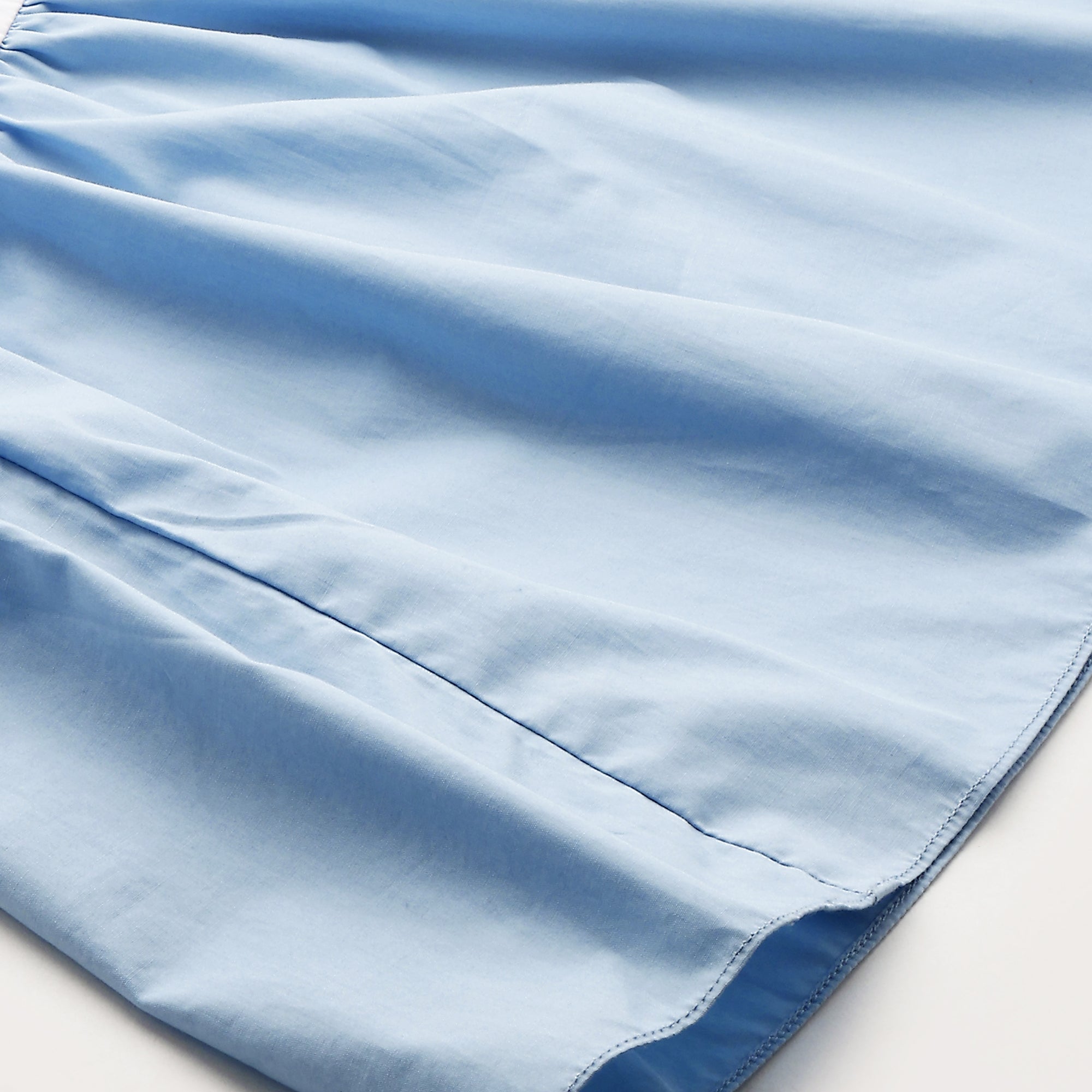 Off-shoulder maxi dress in shades of blue.