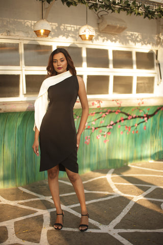 Black and off-white dress with off-shoulder sleeve detailing.