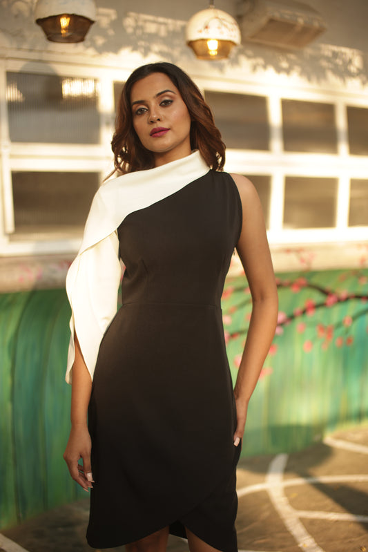 Black and off-white dress with off-shoulder sleeve detailing.